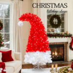 Artificial red and white Christmas trees with lights
